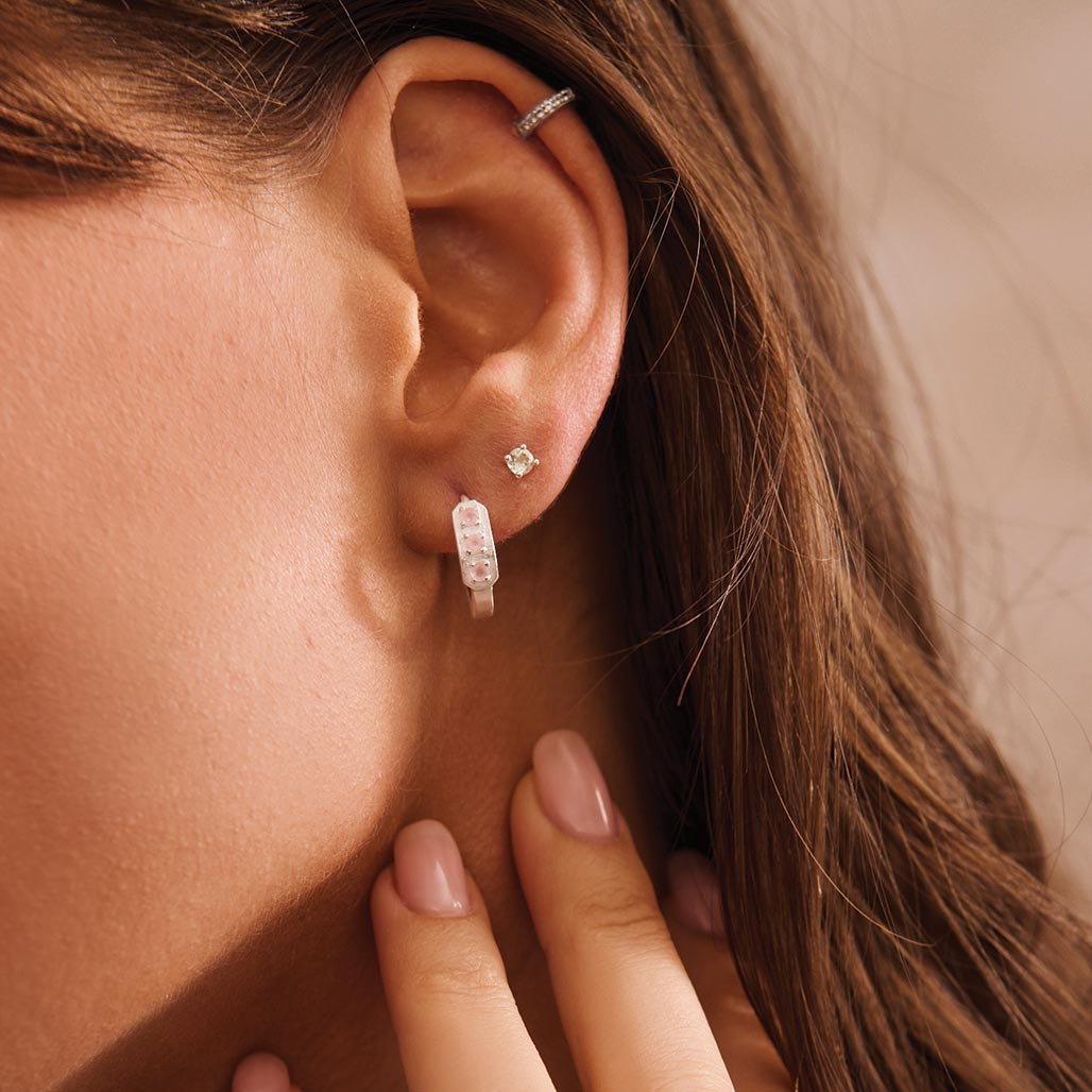 silver huggie earrings on model