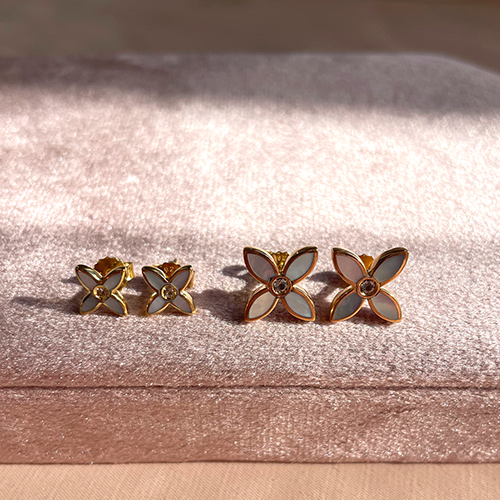 pair of desert flower earrings on velvet pink box