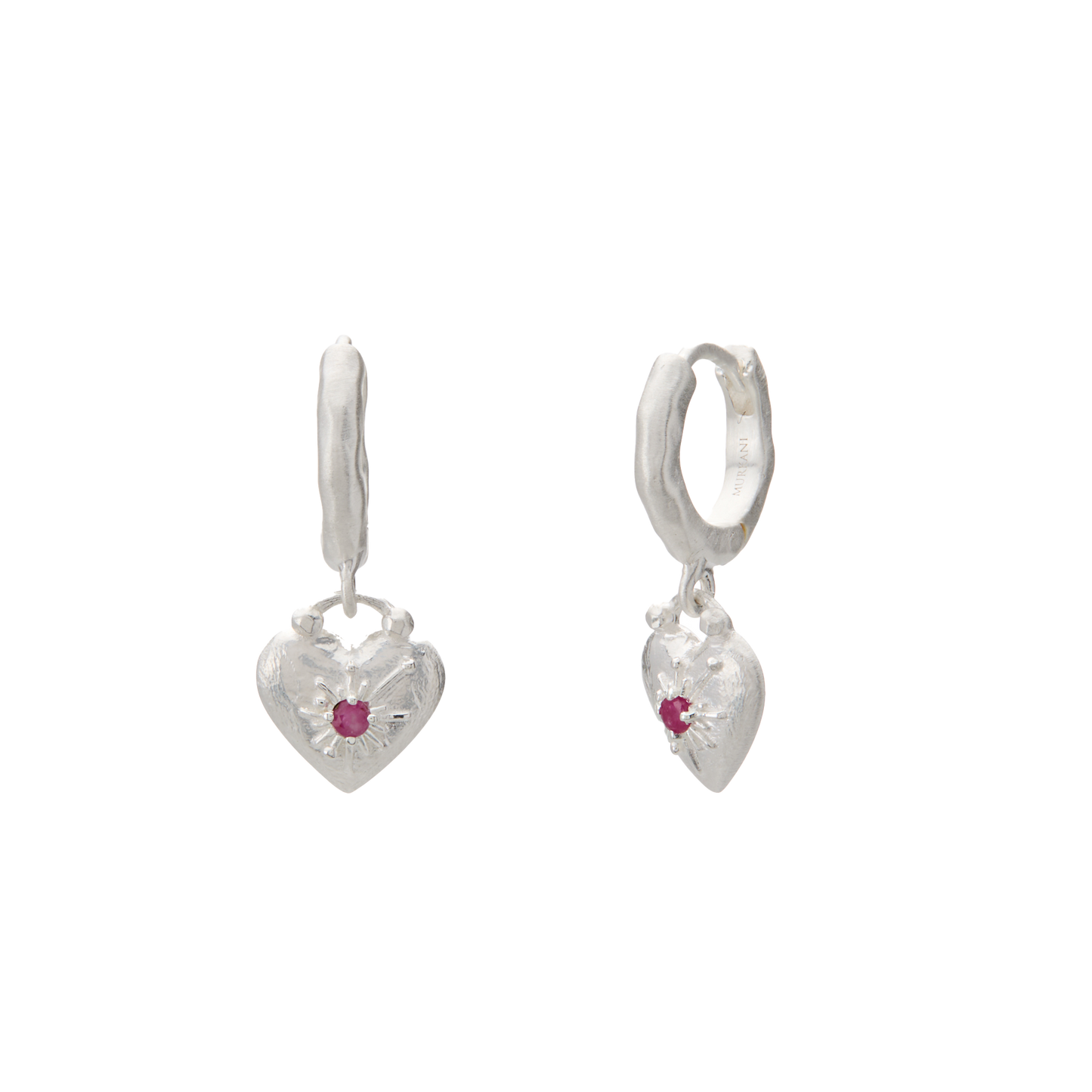 Heart-shaped silver earrings with red gemstones on a white background