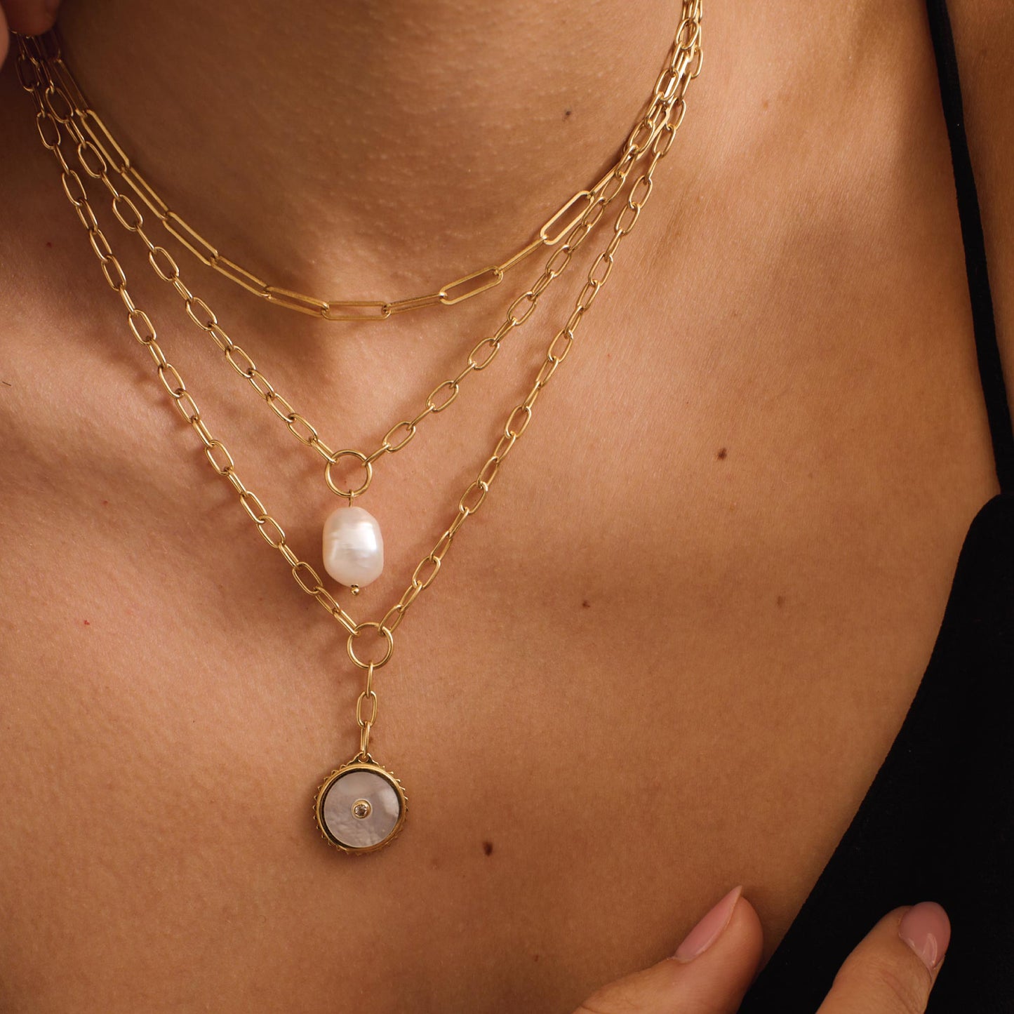 Ethically made artisan gold drop necklace featuring ancient symbolism for courage and strength.