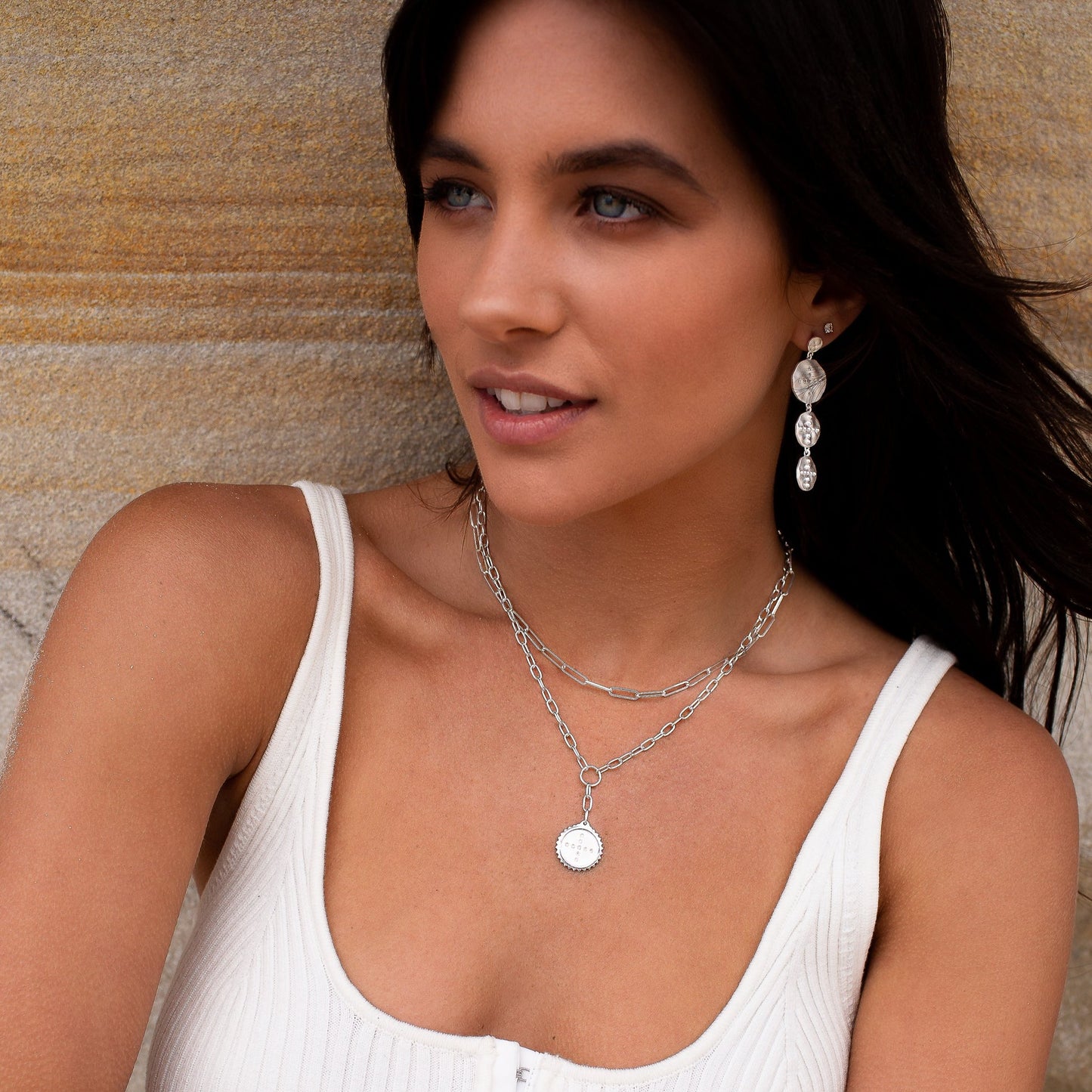 Modern sterling silver drop necklace with Celtic symbolism, featuring white topaz and crafted from natural materials.
