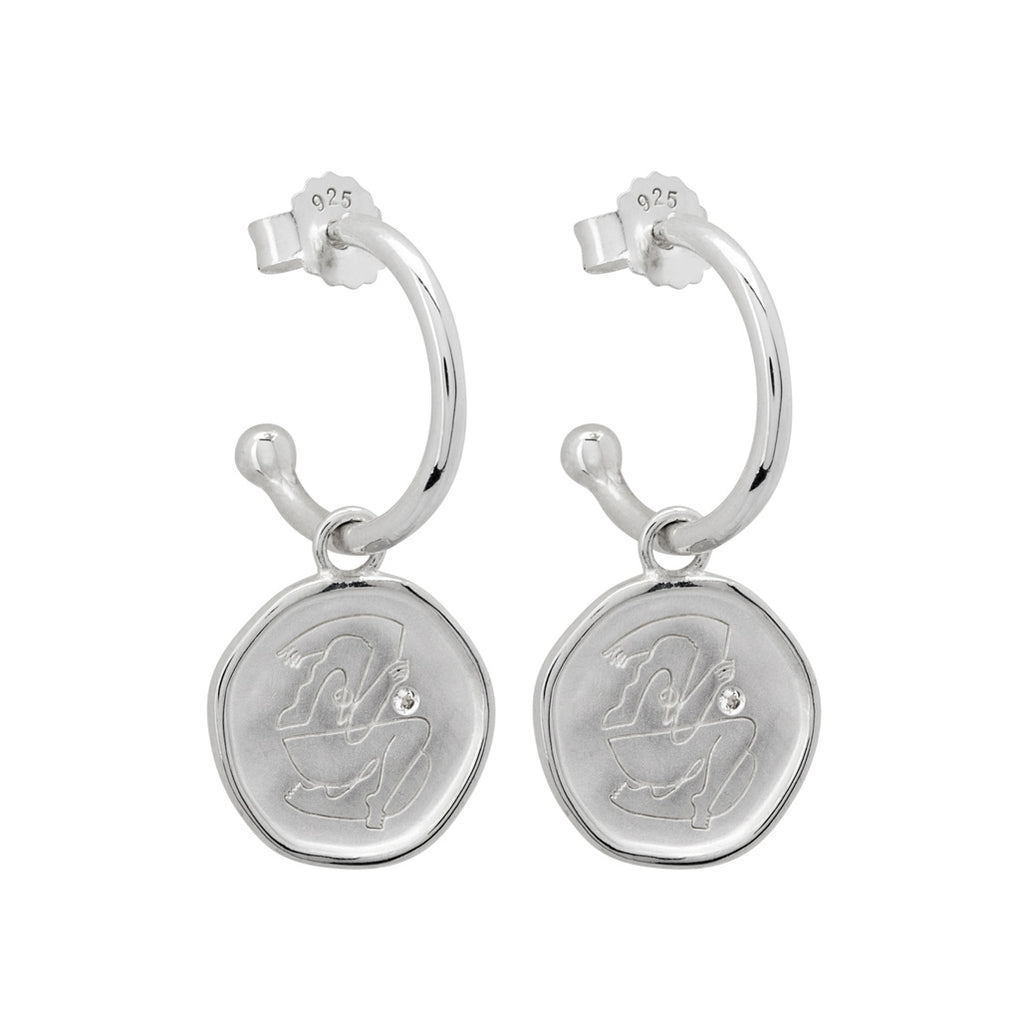 Sterling Silver empowerment hoop earrings, handcrafted by an artisan, showcasing intricate craftsmanship and attention to detail.