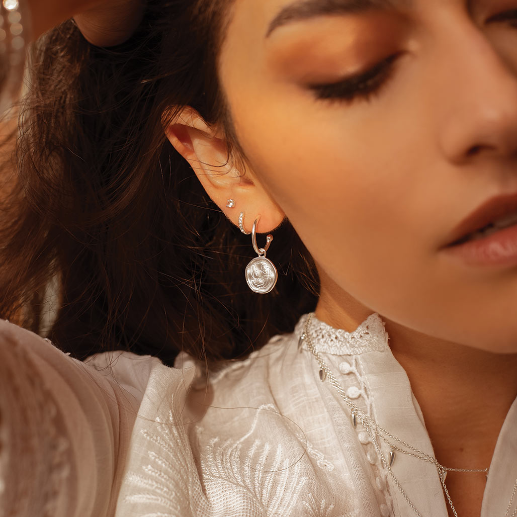 Handcrafted Sterling Silver hoop earrings celebrates the bond between mother and child. Artisan-made and intricately designed.