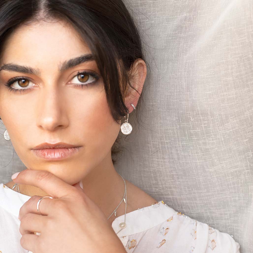 Handcrafted Sterling Silver hoop earrings celebrates the bond between mother and child. Artisan-made and intricately designed.