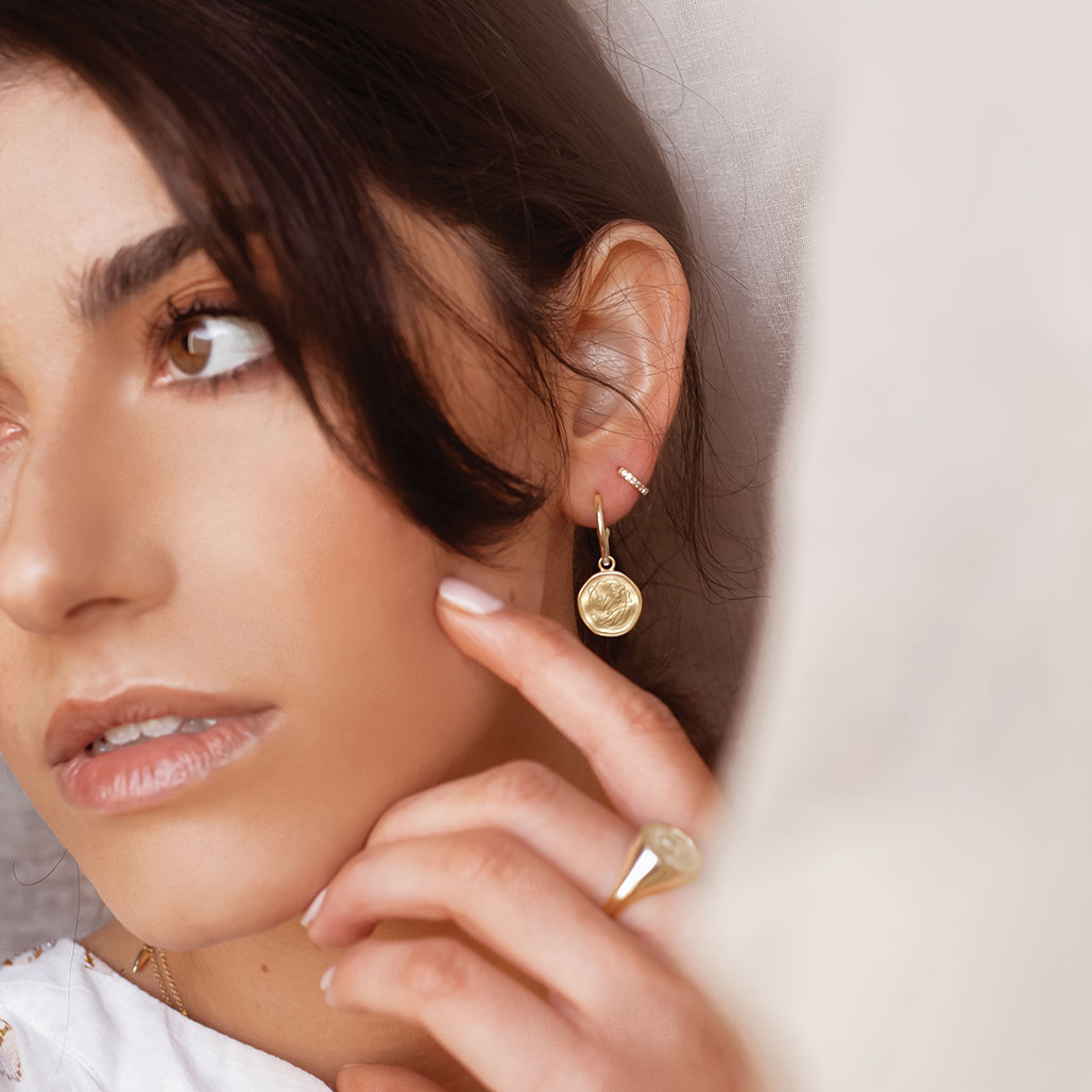 Handcrafted Gold hoop earrings celebrates the bond between mother and child. Artisan-made and intricately designed.