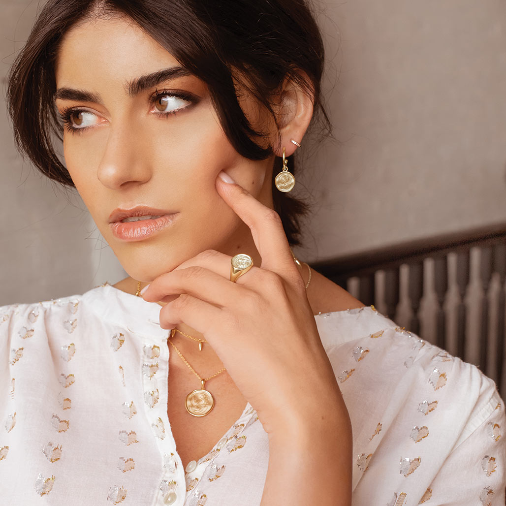 Handcrafted Gold hoop earrings celebrates the bond between mother and child. Artisan-made and intricately designed.