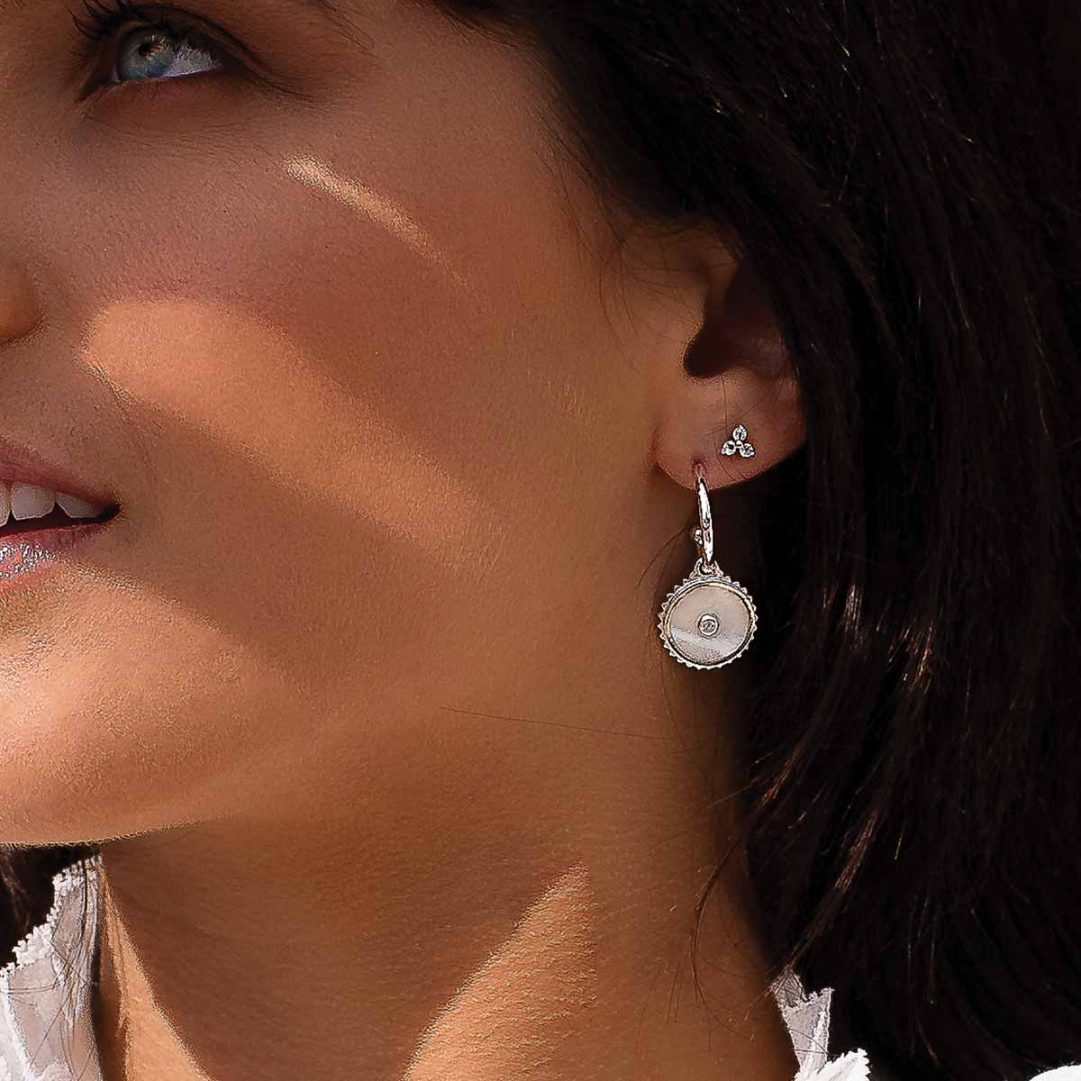 Sterling silver hoop earrings with moonstone, white topaz, and Ailm cross design symbolising fearlessness.