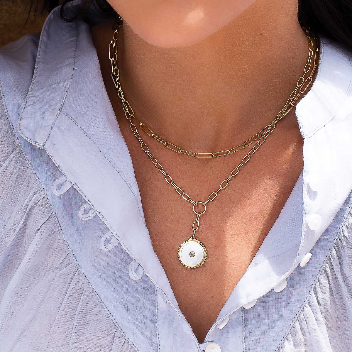 Ethically made artisan gold drop necklace featuring ancient symbolism for courage and strength.