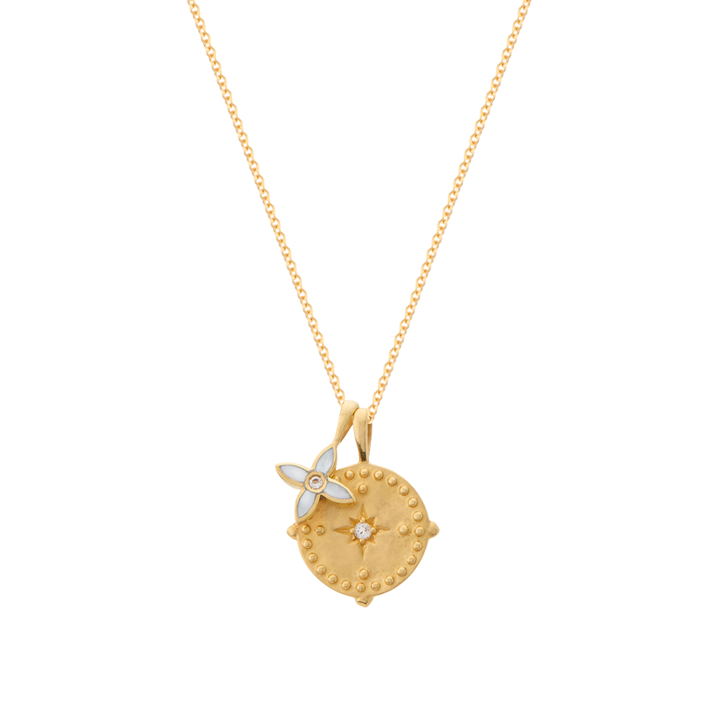 Gold necklace with a decorative pendant on a white background