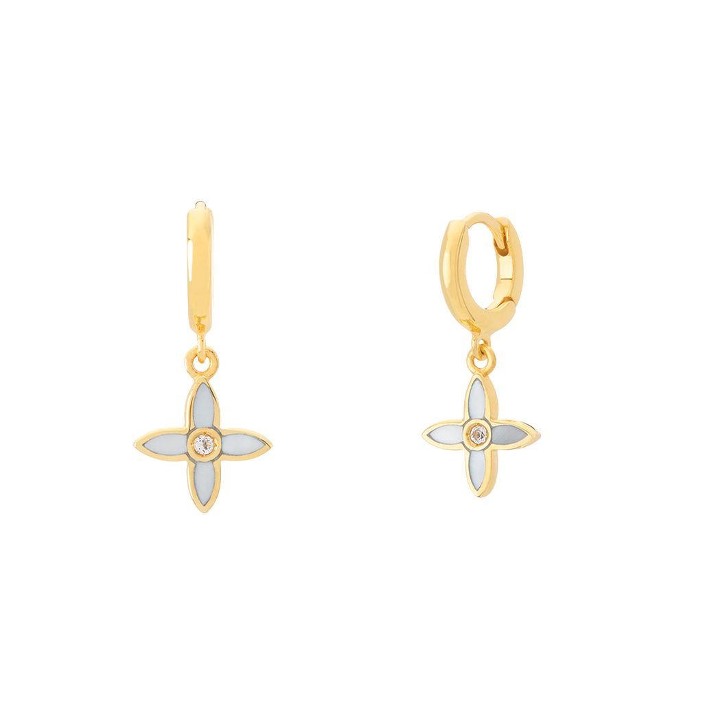 Gold earrings with floral designs on a white background