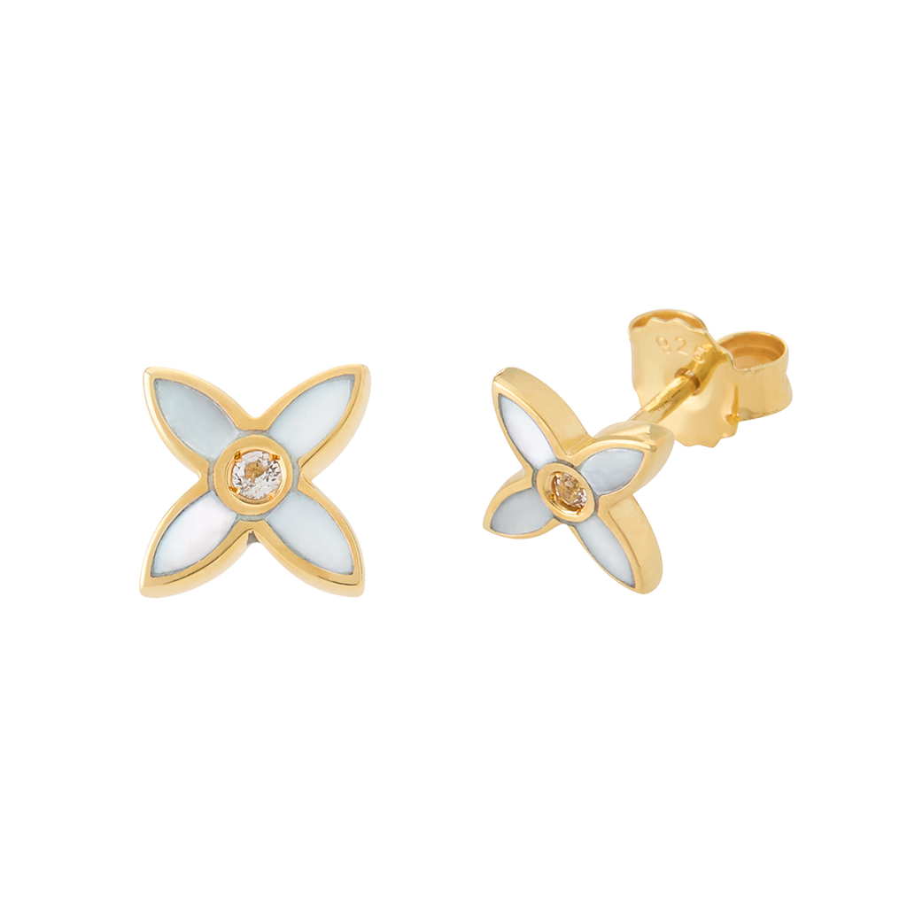 Gold and white flower-shaped earrings on a white background