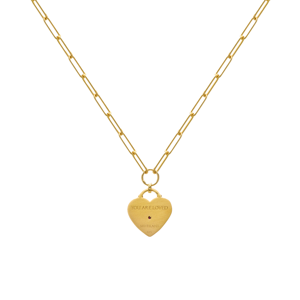 Gold necklace with a heart-shaped pendant on a white background