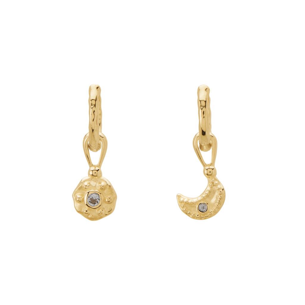 Gold earrings with circular and crescent moon designs on a white background