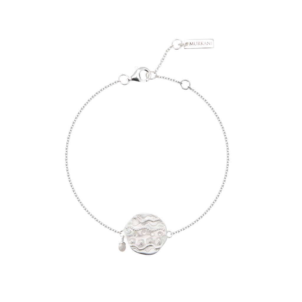 Silver bracelet with a circular design on a white background