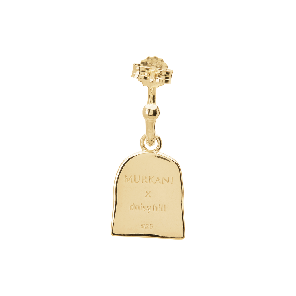 Gold pendant with 'MURANI x daisy hill' engraving on a white background