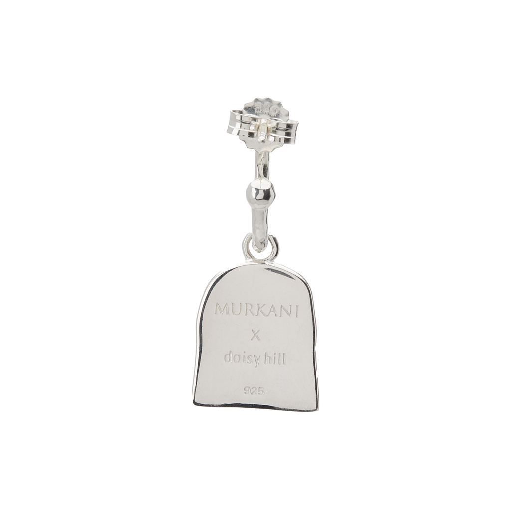 Silver charm with engraved text on a white background