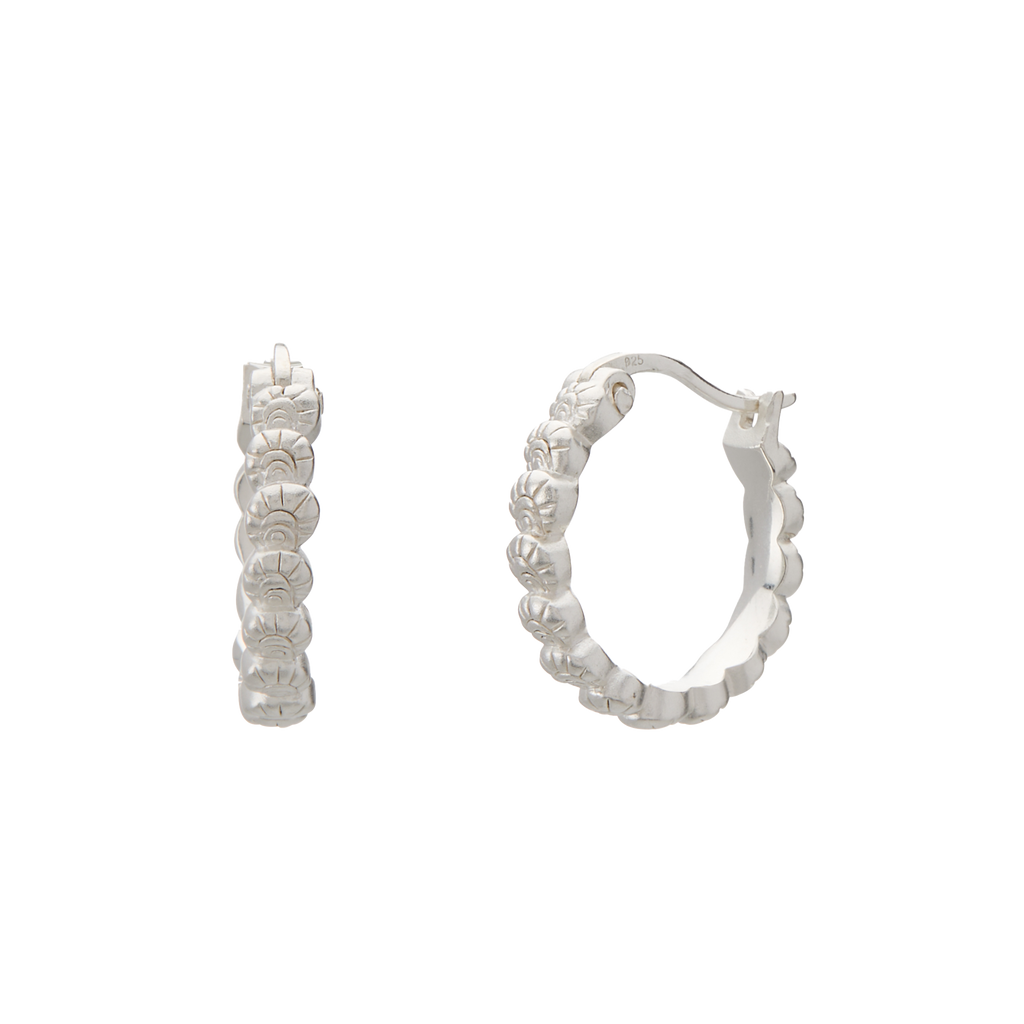 Silver hoop earrings with floral designs on a white background