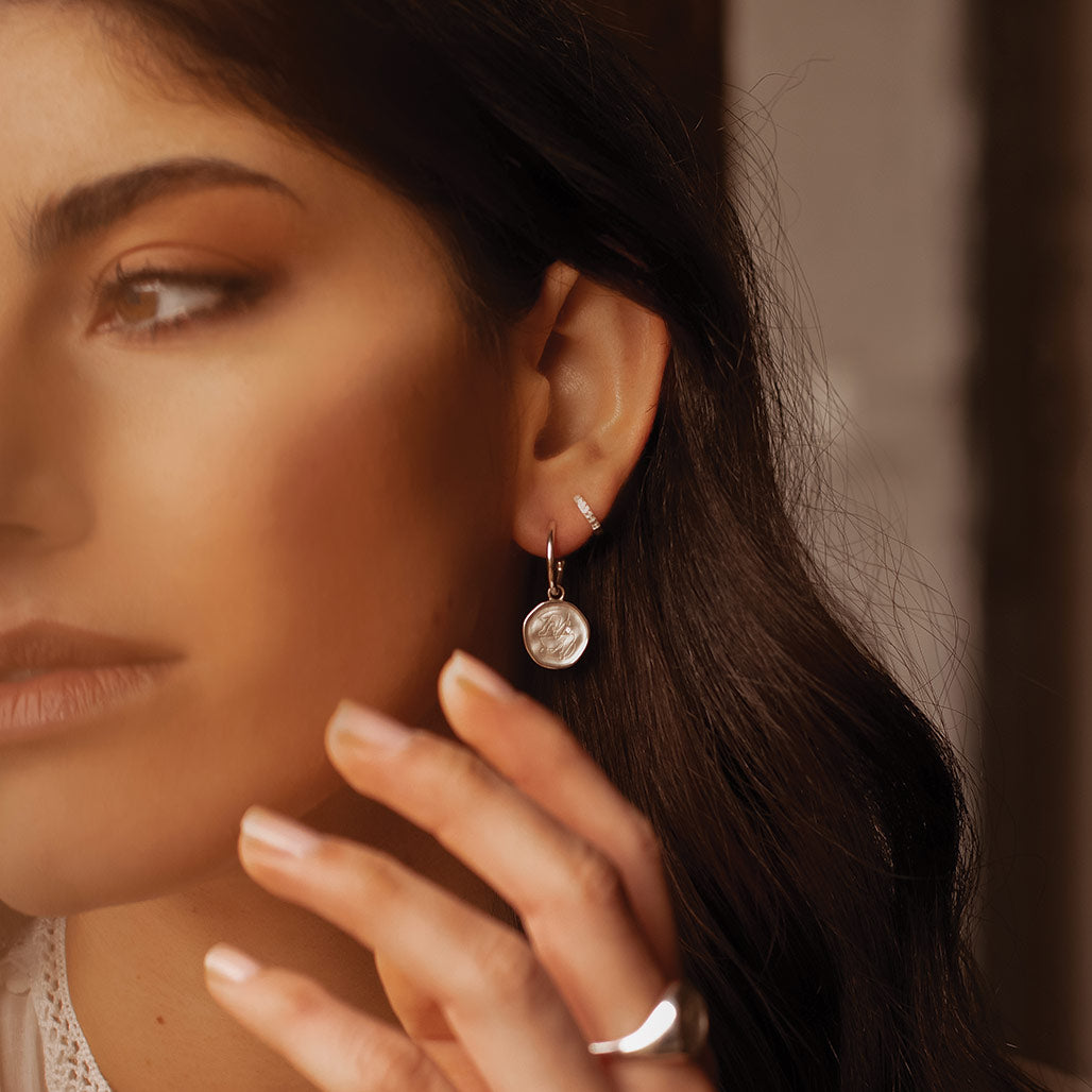 Sterling Silver empowerment hoop earrings, handcrafted by an artisan, showcasing intricate craftsmanship and attention to detail.