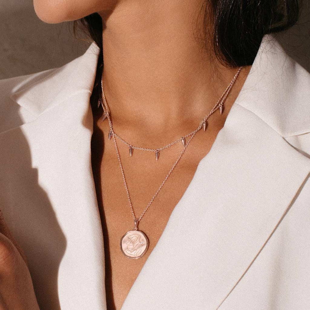 Rose Gold empowerment necklace, handcrafted by an artisan, showcasing intricate craftsmanship and attention to detail.