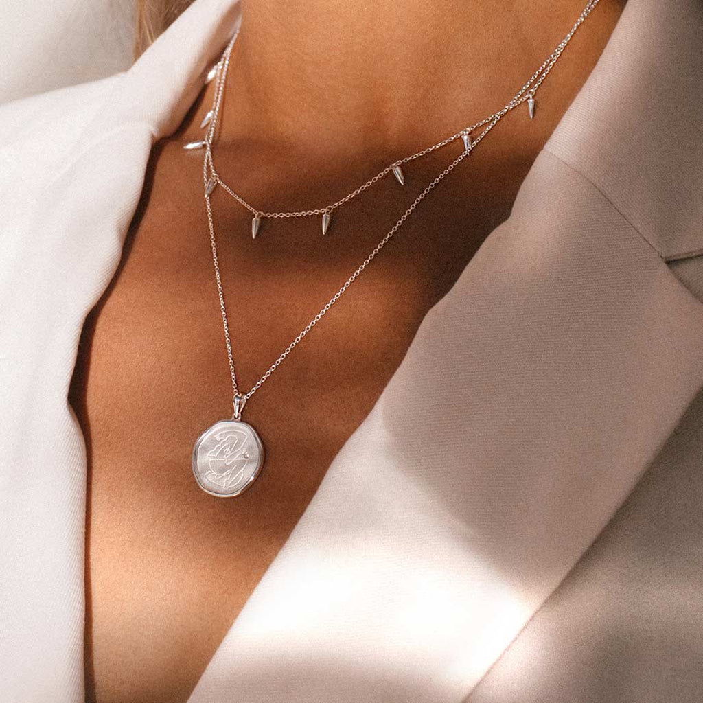 Sterling Silver empowerment necklace, handcrafted by an artisan, showcasing intricate craftsmanship and attention to detail.
