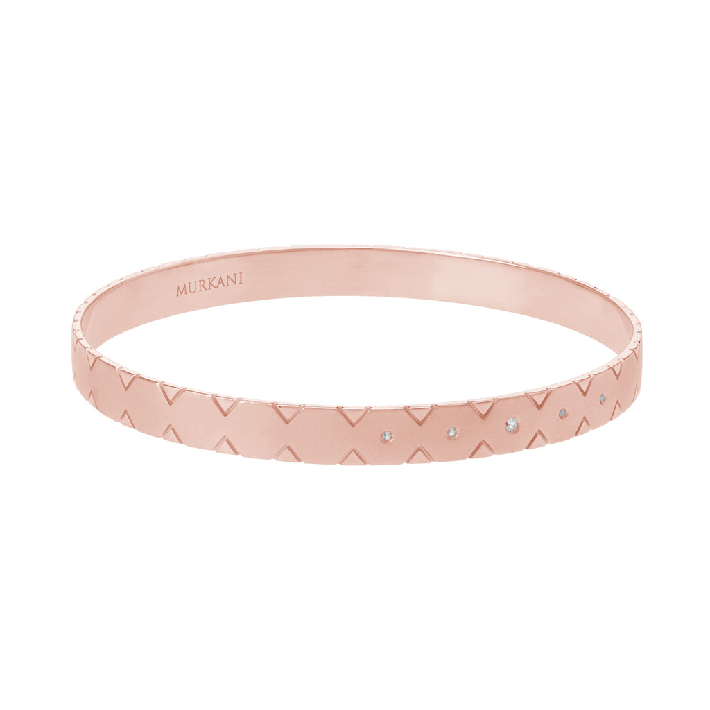Modern rose gold bangle with Celtic-inspired symbolism. A statement piece perfect for stacking with other bracelets.