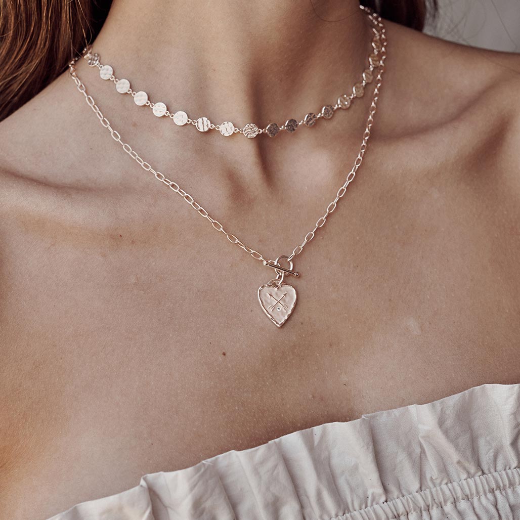 Handcrafted heart fob necklace in rose gold with ancient symbolism. Artisan-made with a charming heart design. 