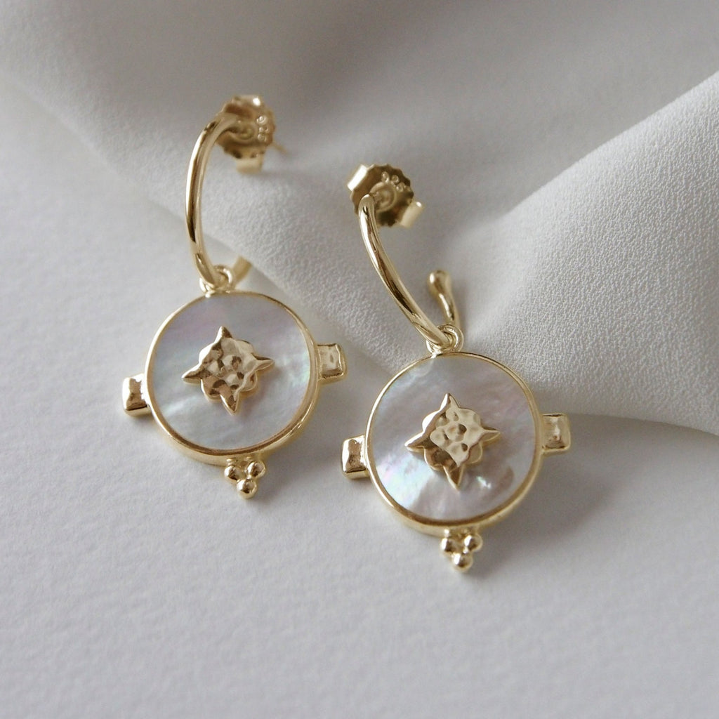 Handcrafted artisan-made hoop earrings featuring a mother of pearl design, set in yellow gold, creating a timeless jewellery piece.