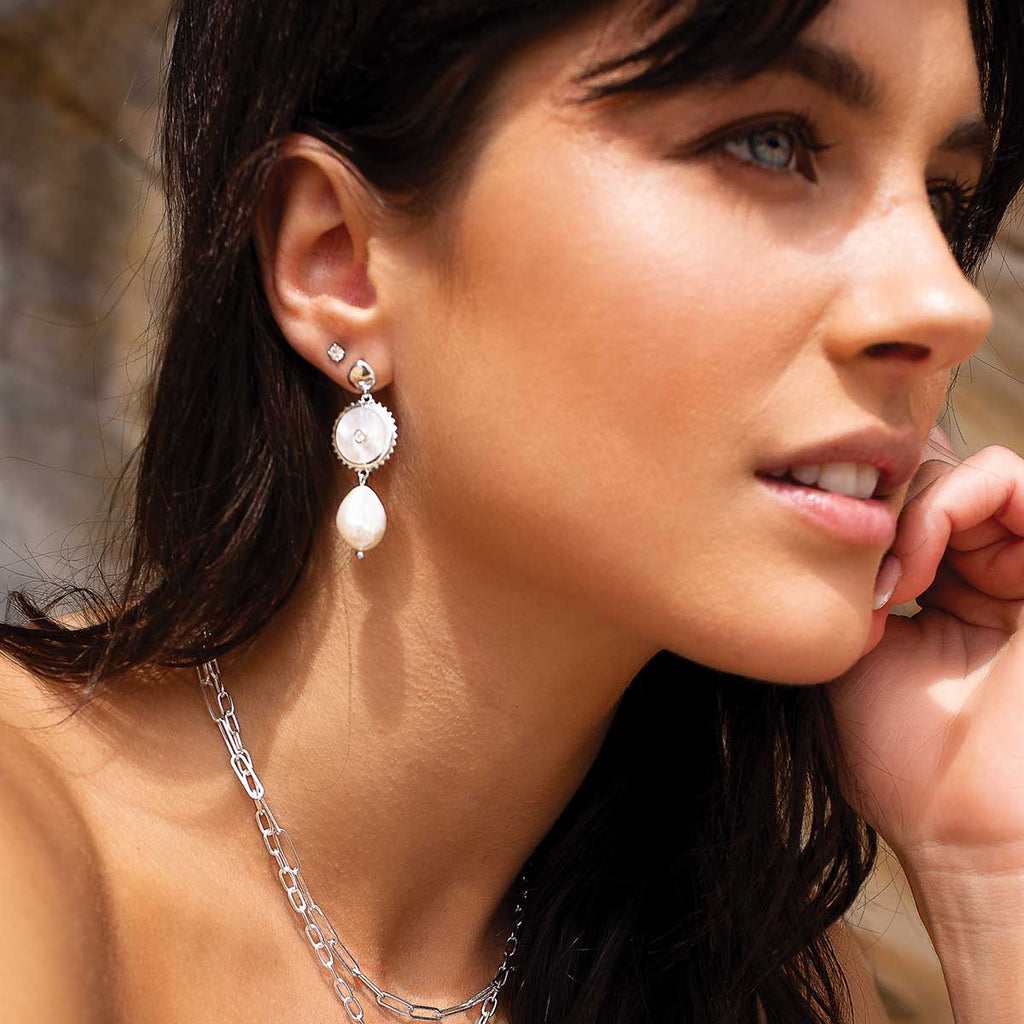 Handcrafted artisanal production of modern sterling silver pearl statement earrings, using long-lasting materials.