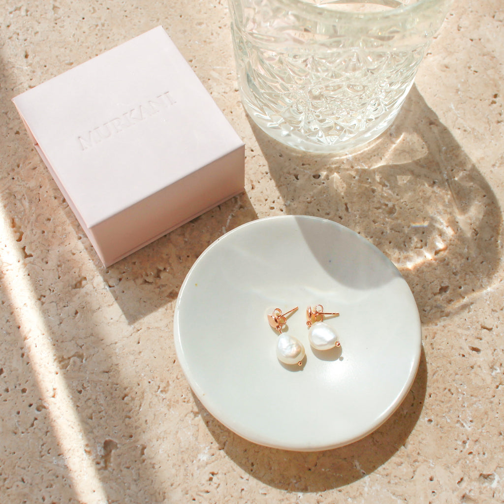 Handcrafted rose gold pearl earrings made with natural materials using ethical and responsible manufacturing practices.