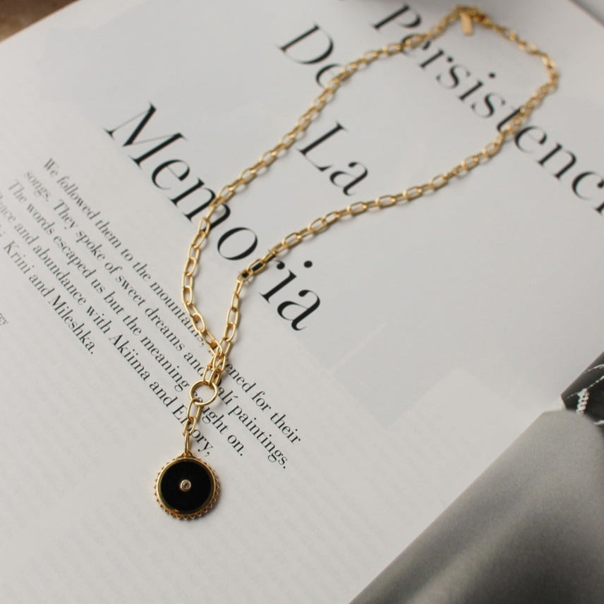 Gold drop necklace with ancient symbolism and black onyx. Artisan-made with ethical production methods, representing strength.
