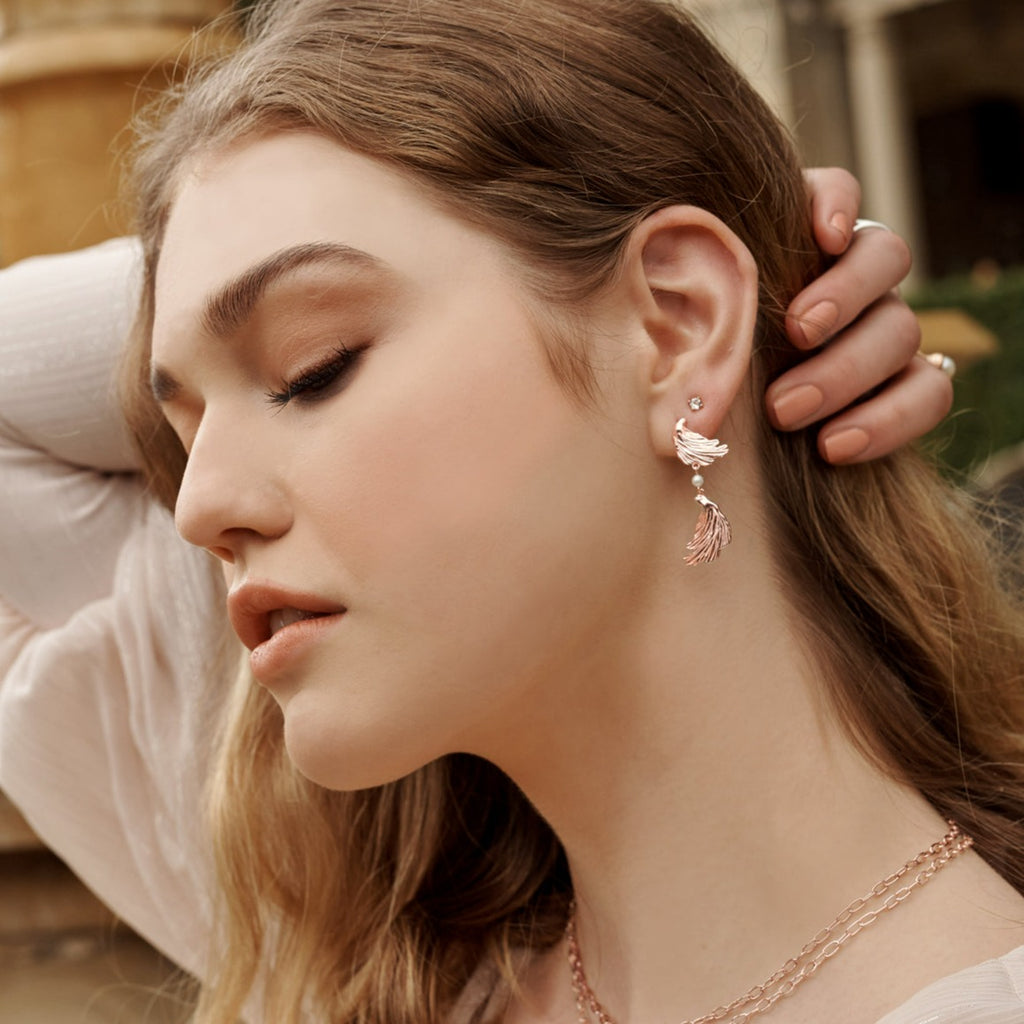 Rose gold statement earrings with a contemporary and abstract design, inspired by love letters and ancient jewellery. 