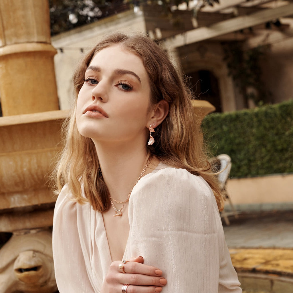 Rose gold statement earrings with a contemporary and abstract design, inspired by love letters and ancient jewellery. 