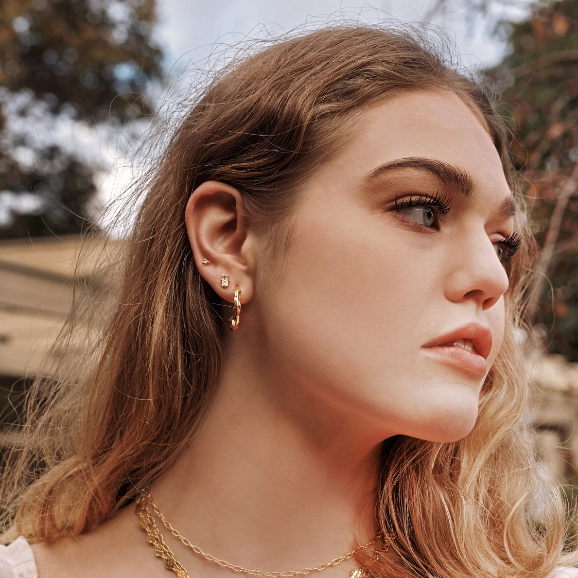 Ethically made, handcrafted gold hoops with a modern, textural design. Artisanal production and artisan-made.